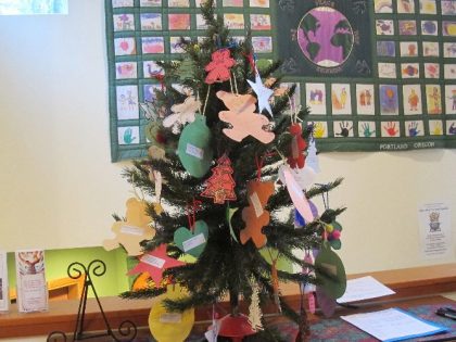 Christmas tree with different colored ornaments with the wishes of kids in need
